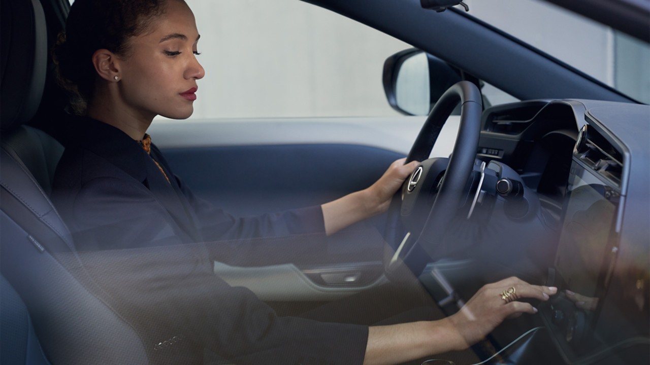 A woman sat in a Lexus RZ 450e