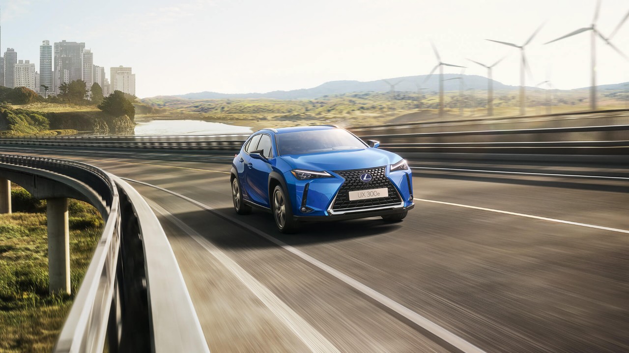 A Lexus UX 300e driving round a corner